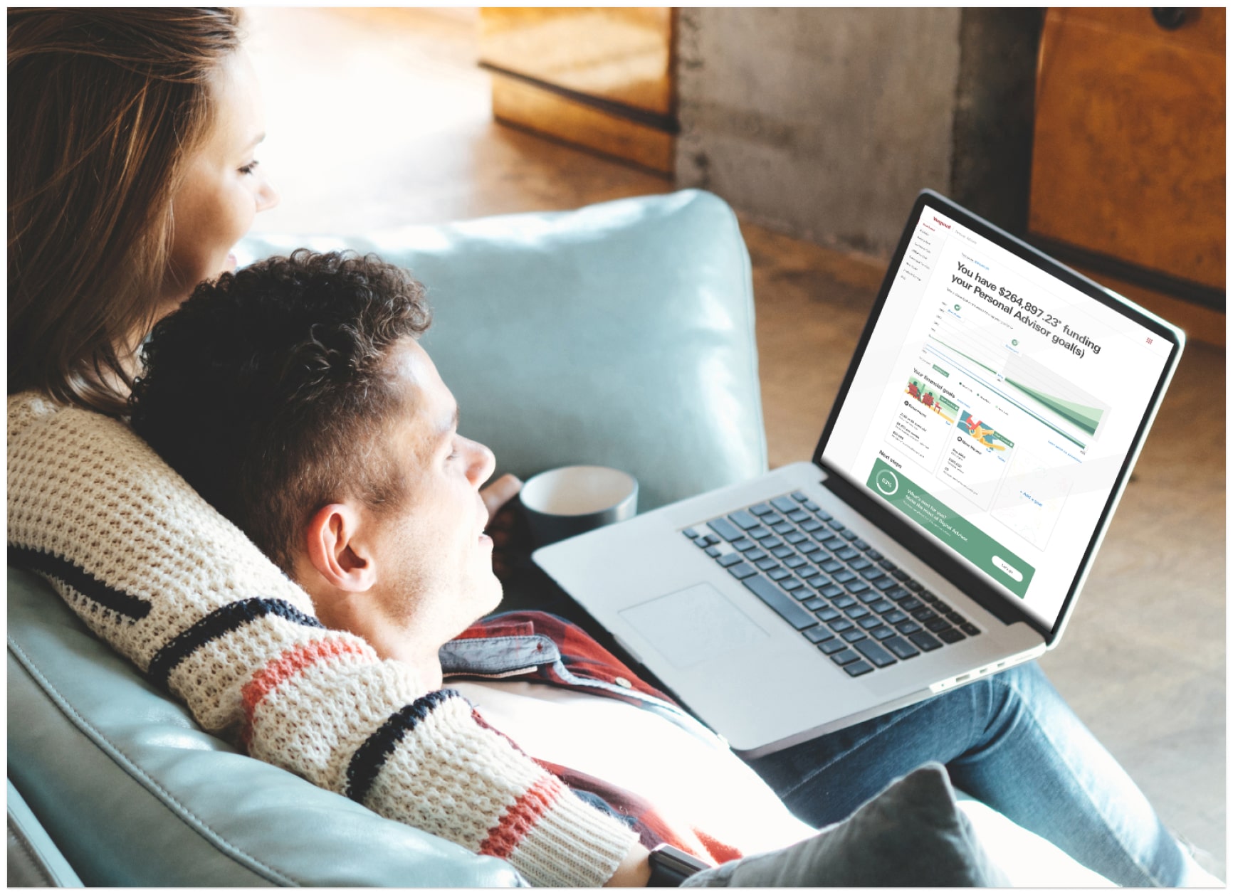 Couple relaxing and looking at a laptop