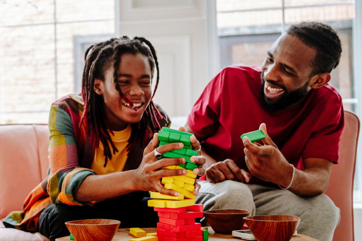 Photo of  father and child playing a game