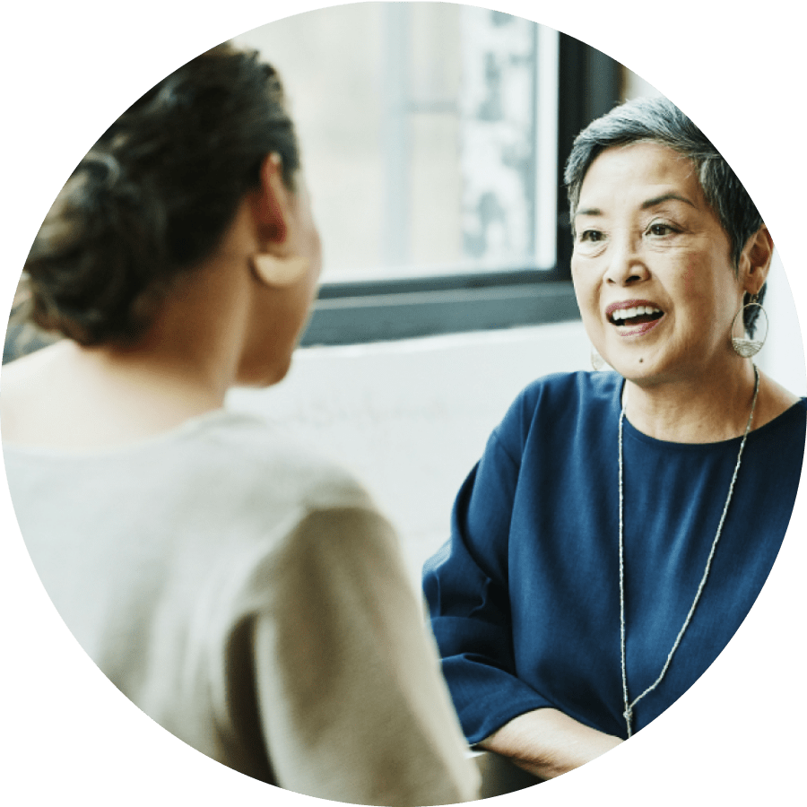 Smiling business person talking to a client in an office conference room